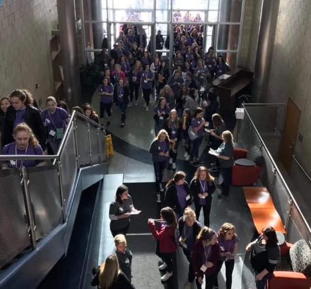 A group of high school students swarming the entrance to the Technology Center